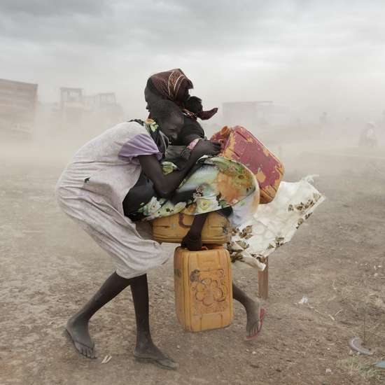 Zwei Mädchen schützen sich im Flüchtlingslager Malakal im Südsudan gegenseitig vor starkem Sandsturm