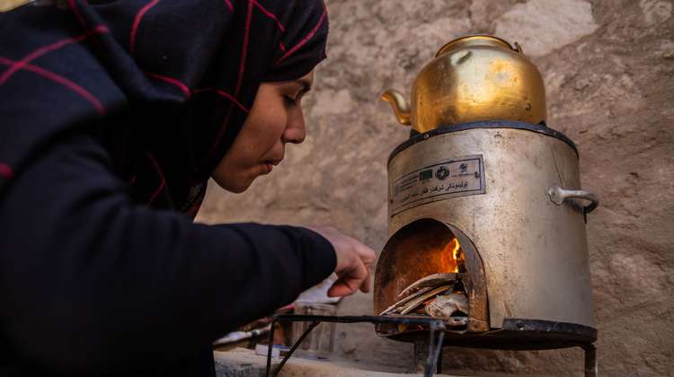 Jetzt für Afghanistan spenden - Bild: Eine Frau in Afghanistan beim Gebrauch eines energiesparenden Herds
