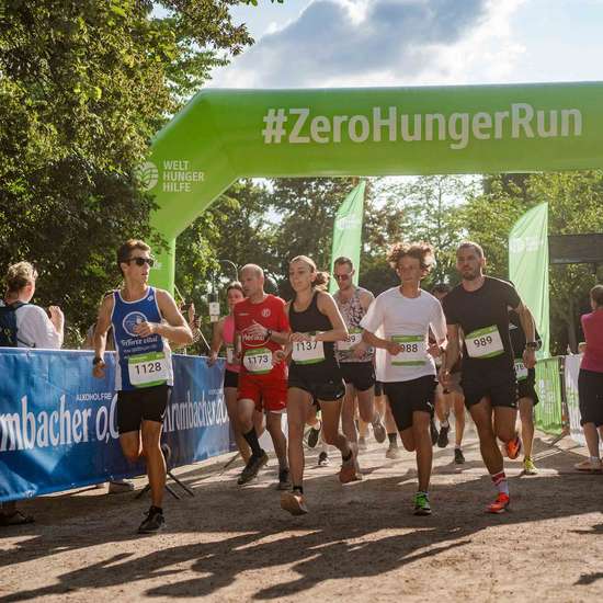 Läufer unter einem aufblasbaren Torbogen mit Aufschrift #ZeroHungerRun