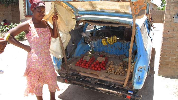 Eine Frau verkauft Obst und Gemüse vor ihrem Marktstand. Viele können sich durch den Anstieg der Lebensmittelpreise nicht mehr alles leisten.