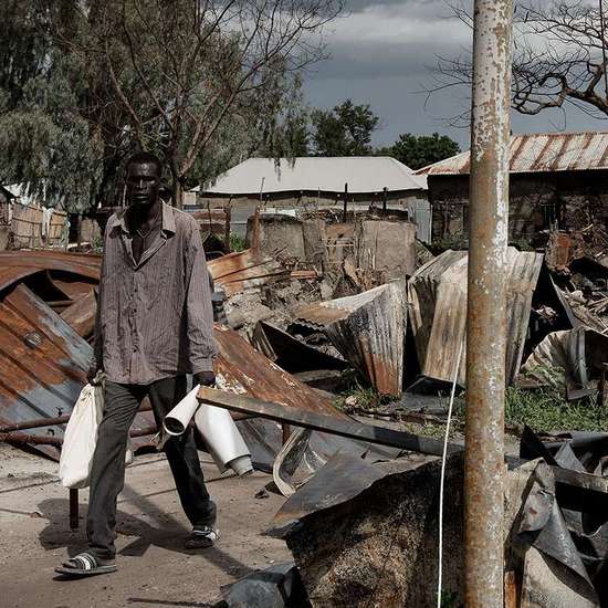 Ein Mann im Südsudan läuft durch die Trümmer einer Wohnsiedlung der Stadt Malakal.