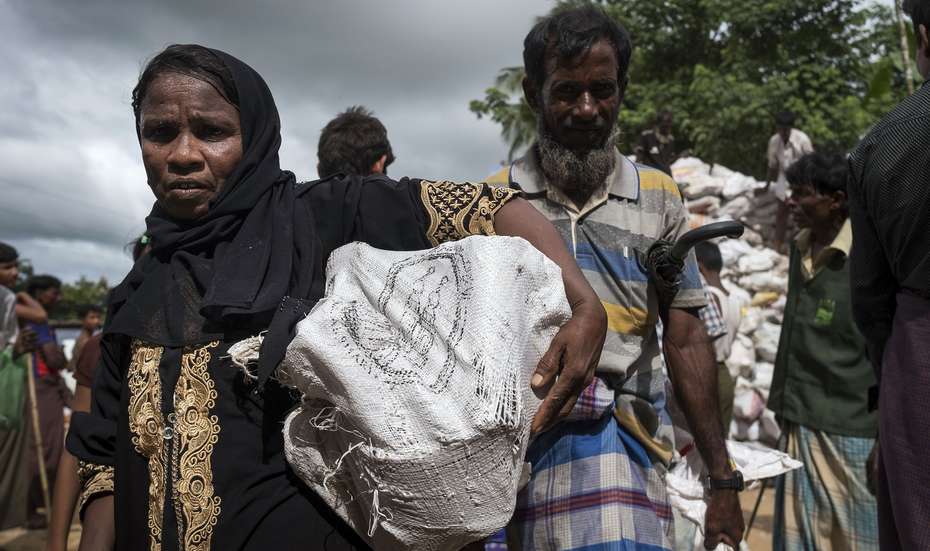 Eine Frau im Flüchtlingscamp Hakimpara, Bangladesch, mit einem Sack voller Brennmaterial. 
