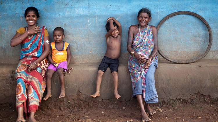 Surgi Pacharia, 27, and her son Mesa Pacharia, 4, are sitting on the town square of Ketokuria near Pakur, Jharkand. Next to them sits Bamri Pacharia, about 60, and her grandchild.