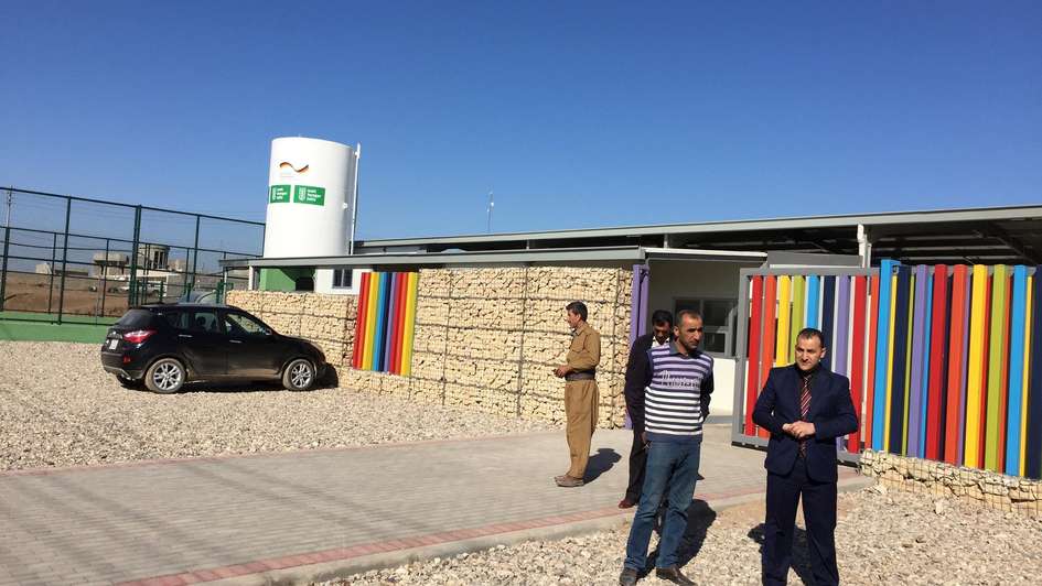 Vier Irakis vor der neuen Schule in der Nähe von Dohuk