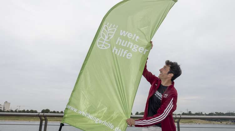 Ein Mann mit einer Welthungerhilfe-Fahne