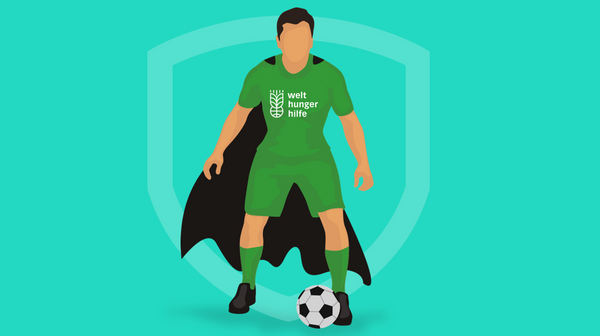 Ein Fußballer im Welthungerhilfe-Trikot mit Superhelden-Umhang und Ball
